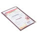 A burgundy Menu Solutions triple panel menu jacket on a table with a menu in it.