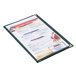 A Menu Solutions green triple panel menu jacket on a table with a menu inside.