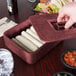 A person putting a burrito into a Raspberry HS Inc. multi-purpose container.