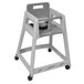 A grey plastic Koala Kare high chair with black wheels.