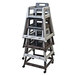 A stack of three gray Koala Kare plastic high chairs with casters.