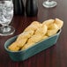 A tray of bread sticks in a black breadstick basket.