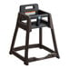 A brown Koala Kare stackable plastic high chair on a table.
