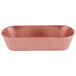 A pink rectangular HS Inc. paprika cracker and breadstick basket on a white counter.