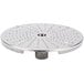 A circular metal Robot Coupe hard cheese grating disc with many small holes.