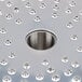 A Robot Coupe hard cheese grating disc with a circular hole in a metal plate.