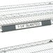 A gray Metro slanted plastic label holder on a shelf.