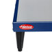 A blue and silver Hatco heated shelf on a table with a red logo.