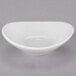 A white Tuxton China ramekin on a white surface.