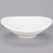 A Tuxton Napa Alumatux white fruit bowl with a small rim.