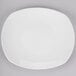 A Tuxton AlumaTux pearl white china platter with a small rim.