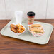 A Carlisle white Glasteel tray with food and a drink on it.