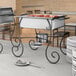 A table set with a Choice half size chafer with food on it.