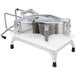 A Vollrath Redco Tomato Pro tomato slicer with a metal handle.
