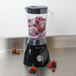 A Proctor Silex blender with ice and berries in it.