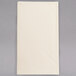 A white Hoffmaster paper dinner napkin on a gray surface.