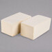 A stack of ivory Hoffmaster paper dinner napkins.