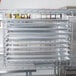 A Metro Chrome Tray Slide holding trays on a rack.