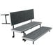 A grey National Public Seating choral riser platform with black trim.