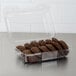 A Dart clear hinged plastic container filled with chocolate cookies.