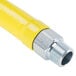 A yellow T&S gas appliance connector hose with silver metal fittings.