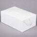 A white take-out lunch box with a lid.