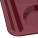 A dark cranberry Carlisle melamine 6 compartment tray.