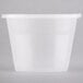 A white plastic Newspring oval souffle container with a clear lid.