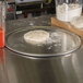 An American Metalcraft heavy weight aluminum pizza pan on a counter.