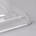 A clear plastic rectangular tray cover on a white surface.