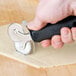 a hand holding a black tool