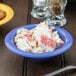 A peacock blue melamine bowl filled with crab salad.
