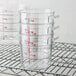 a stack of clear measuring cups