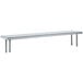 A stainless steel rectangular shelf with legs on a table.