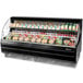 A black Turbo Air low profile horizontal air curtain display case on a deli counter with food in it.