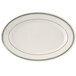 A white oval china platter with green lines on the rim.
