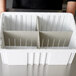 A white Long Metro tote box divider with four compartments.