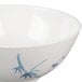 A white melamine bowl with a blue bamboo design.