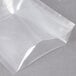 An ARY VacMaster clear plastic vacuum packaging bag on a grey surface.