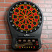 An Arachnid CricketPro dart board on a brick wall.