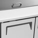 A white cabinet with a silver handle on a Turbo Air refrigerated prep table.