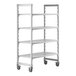 A white plastic Cambro Camshelving® Premium mobile shelving unit with four shelves and wheels.