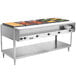 A Vollrath ServeWell electric hot food table with trays of food on a table.