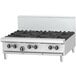 A stainless steel Garland countertop gas range with a griddle over burners.