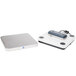 A white rectangular Edlund digital pizza scale with a blue logo.