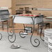A Choice half size chafer on a table with white plates and a spoon on a stand.