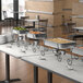A buffet table with a Choice 4 Qt. Half Size Chafer on a black wrought iron stand.