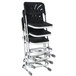 A stack of black National Public Seating Elephant Z-Stools with backrests.