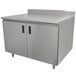 A stainless steel cabinet with two doors on a stainless steel work table.