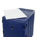 A navy blue Cambro mobile cart with a white rectangular object on top.